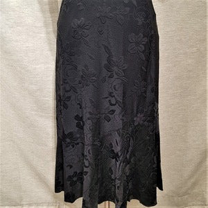 Detailed view of Flared black skirt in self print embellished with stones