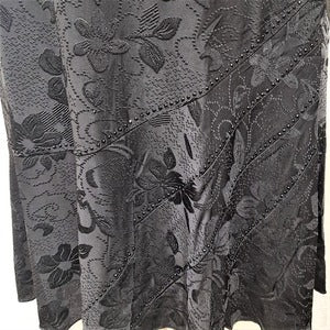 Details of the self print and stone embellishment on black skirt