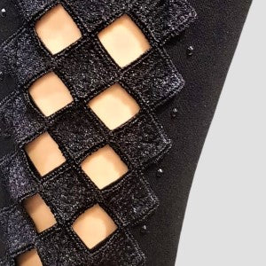 Closer view of lace detailing on side of black leggings