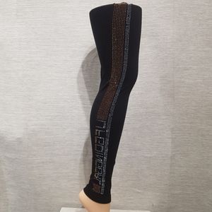 Black leggings with dual color stones on the outer side