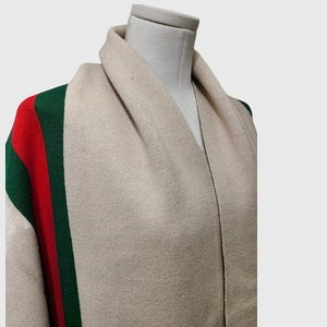 Detailed view of cream color cape with sleeves