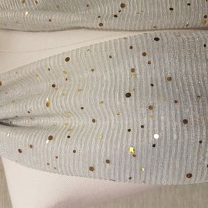 Detailed view of glittery white crinkled scarf
