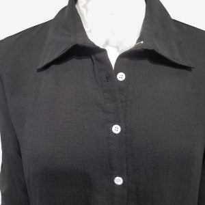 Pointed collar detail of black button down dress shirt