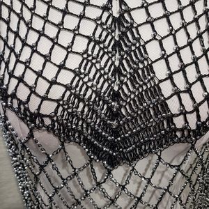 Detailed view of dressy black capelet with shimmery beads