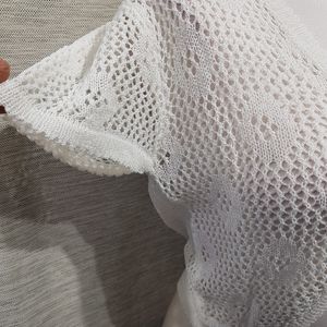 View of the sleeves for white crochet shrug
