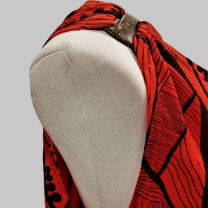 Side view of red with black print, sleeveless summer top