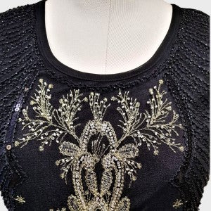 Detailed view of sequin work on black sleeveless top