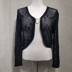 Full view of black crochet shrug with long sleeves