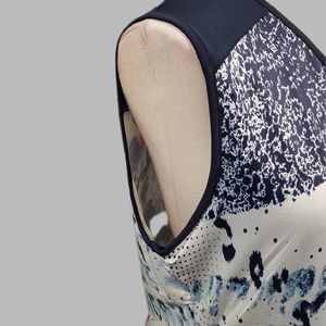 Side view of sleeveless top in multi-colored print