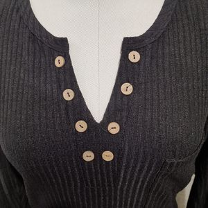 Notch neckline detailed view of black colored top
