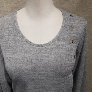 Neckline detail of grey long sleeve top