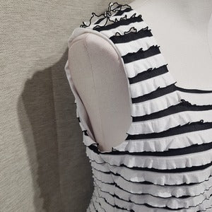 Side view of white and black ruffled top