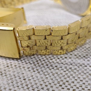 Detailed view of chain strap of gold wristwatch