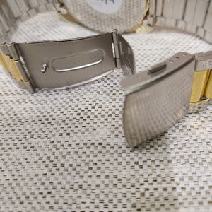 Unfolded clasp closure on dual tone wristwatch for men