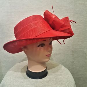 Side view of formal dress hat in red with bow and feathers