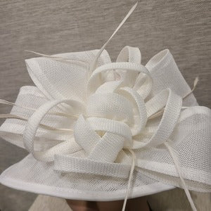Bow and feather detail of formal dress hat in white