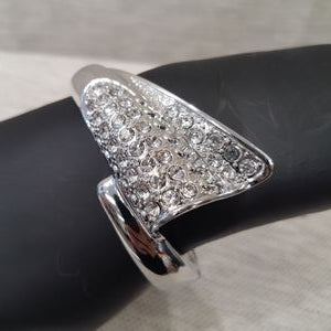 Detailed view of silver color bracelet adorned with clear stones