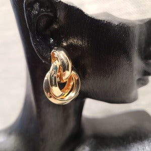 Detailed side view of Twined hoop earrings in gold frame