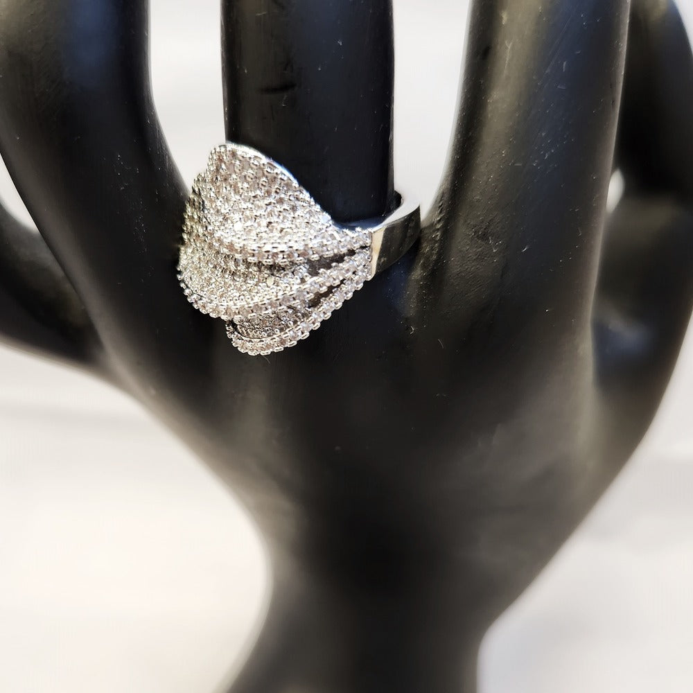 Detailed view of Modern folding petal ring set with delicate clear stones