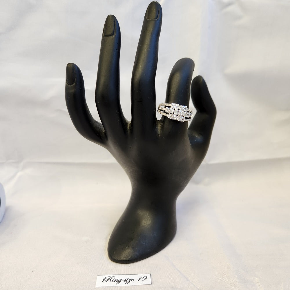 Silver color ring displayed on a mannequin hand