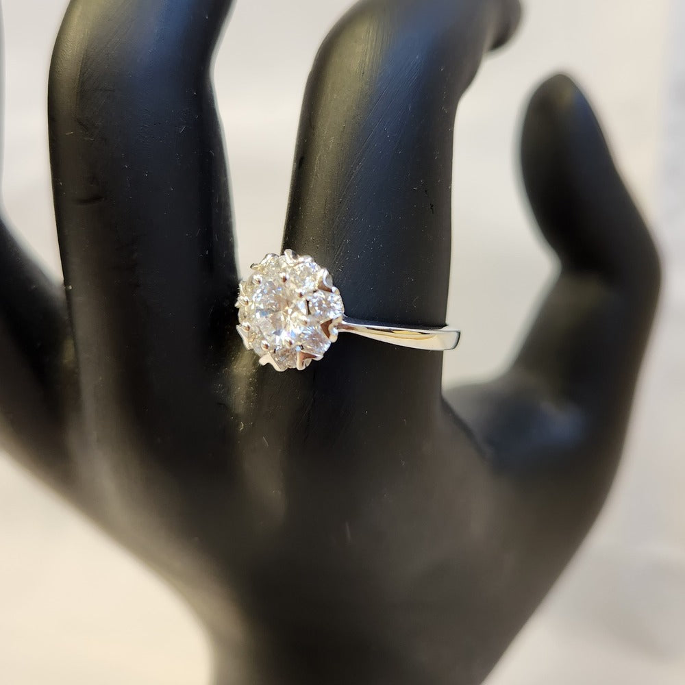 Classic halo shaped ring displayed on a mannequin