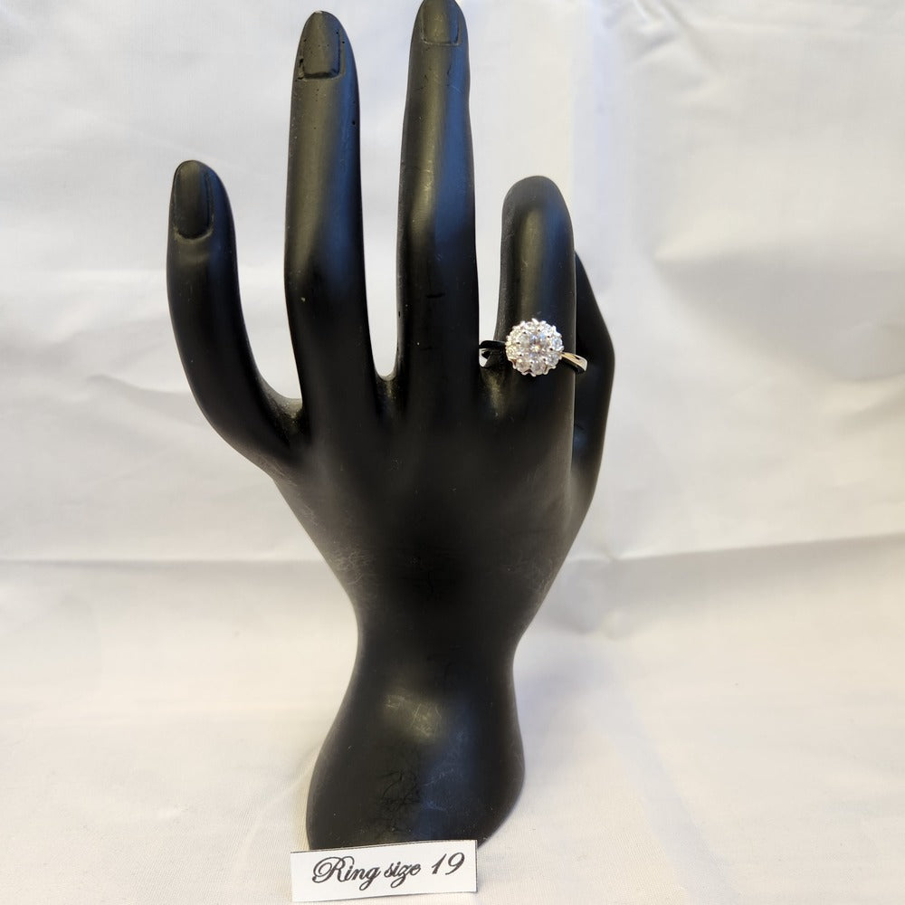 Alternative view of Classic halo shaped ring on stand