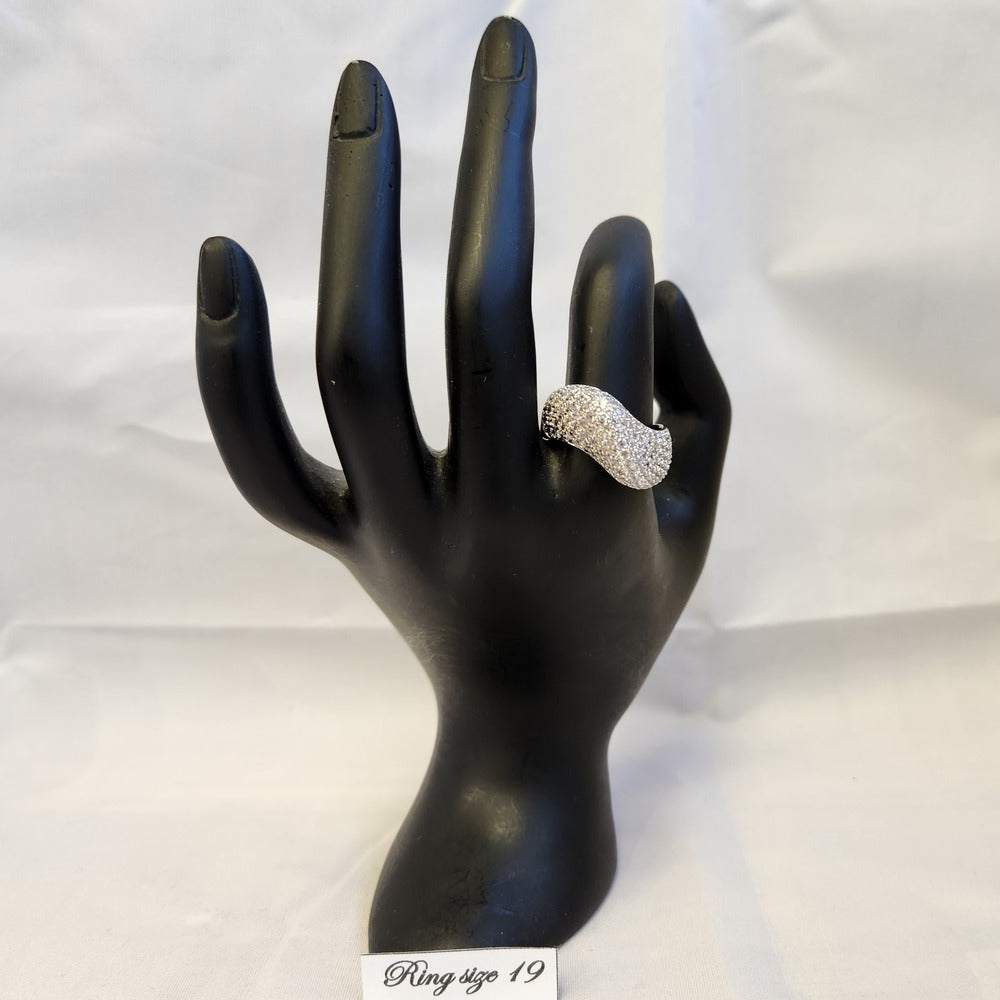 Curved ribbon shaped stone studded ring on a mannequin stand