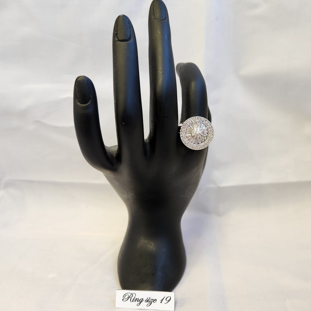Baguette and round cut multistone halo ring on a stand