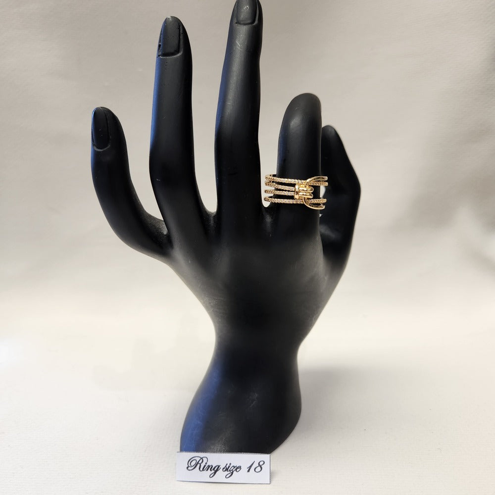 Multi strand modern gold colored ring on mannequin stand