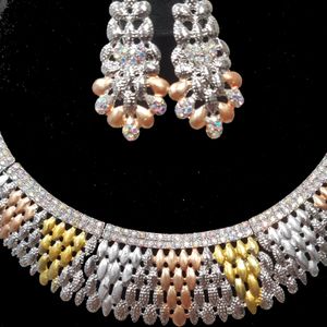 Closer view of necklace and earrings of five piece jewelry set