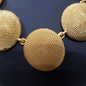 Detailed view of textured gold color disc