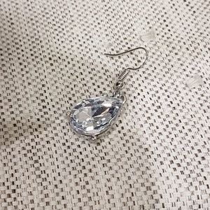 Fish hook dangle earrings with pear shaped stone
