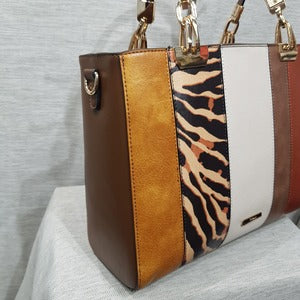 Side view of Fashion handbag with colorful panels and brown wallet