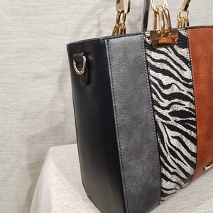 Side view of Fashion handbag with colorful panels and black wallet