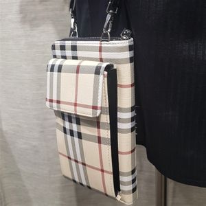 Detailed view of small black strap plaid pattern side bag