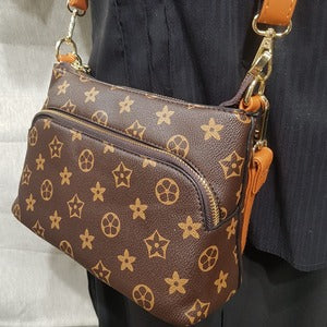 Front zipper compartment on floral pattern side bag