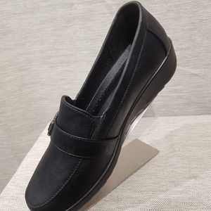 Side view of black shoes with small platform heel