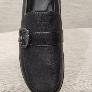 Buckle on top of black shoes with small platform heel