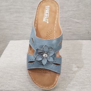 Front view of light blue slip-on sandals
