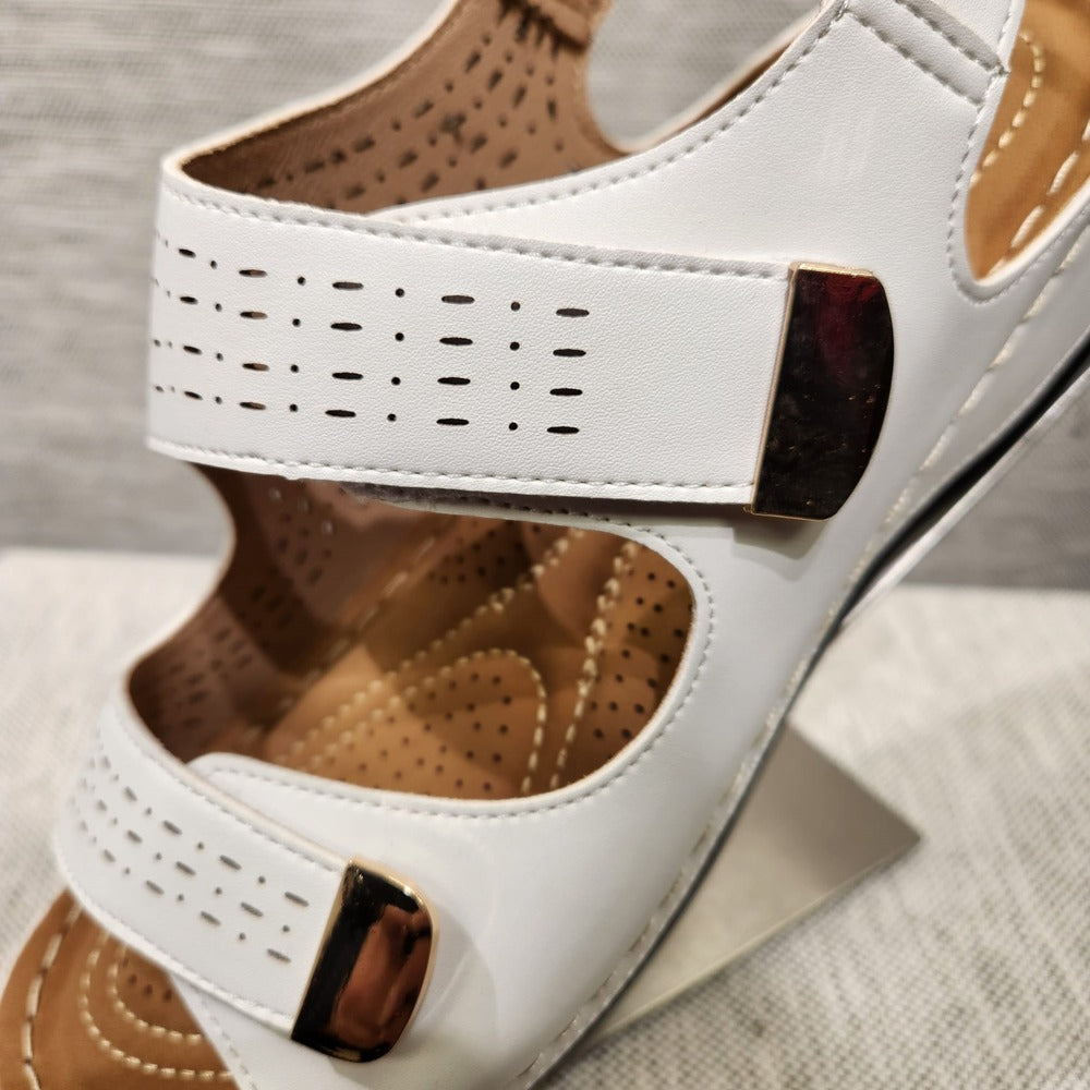 Detailed view of front strap with velcro closure and gold color metallic trim