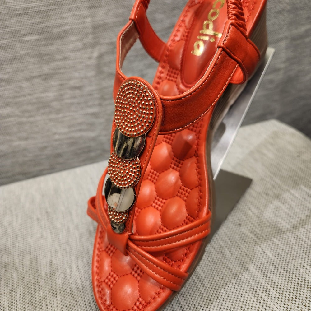 Closer view of top vertical strap embellished with textured gold and orange discs