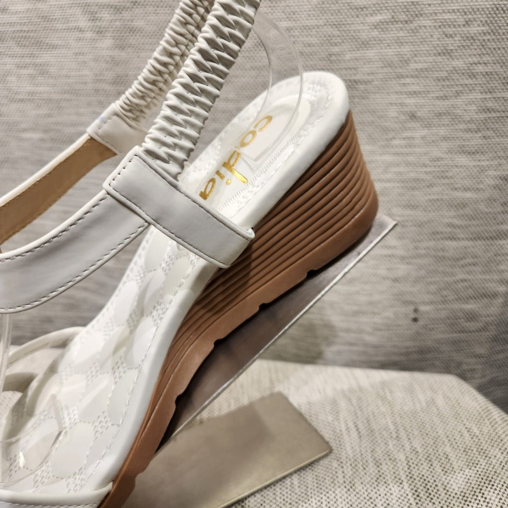 Detailed view of tan heel of of white upper summer sandal