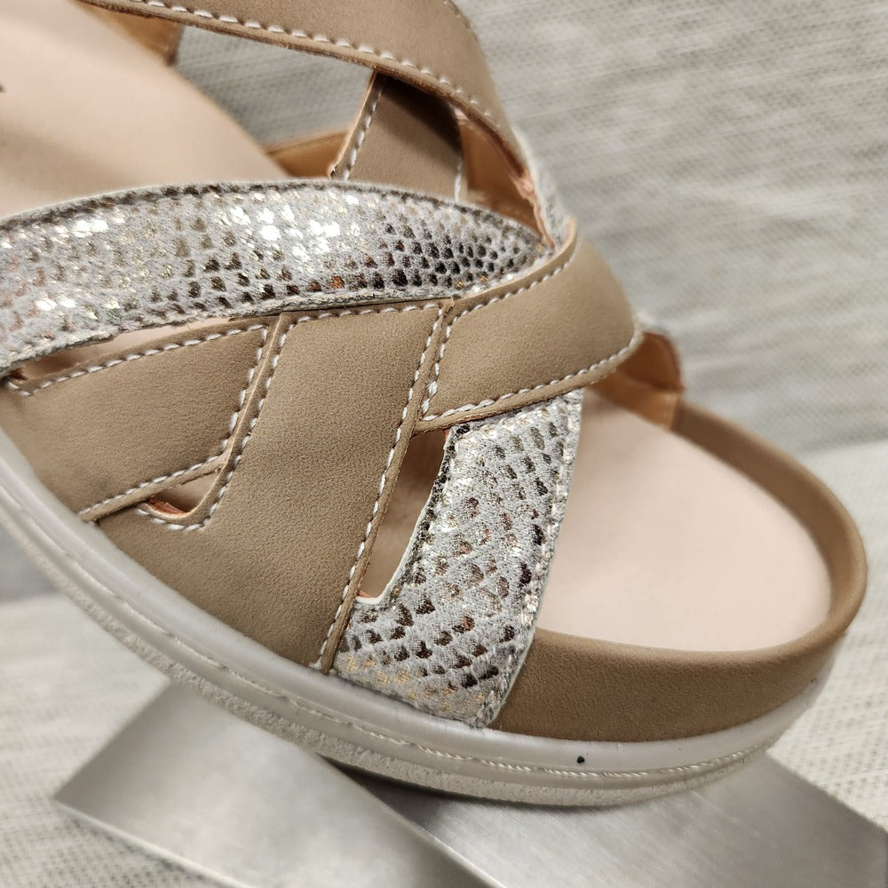 Deep cupping feature of sandal with taupe and shimmery straps