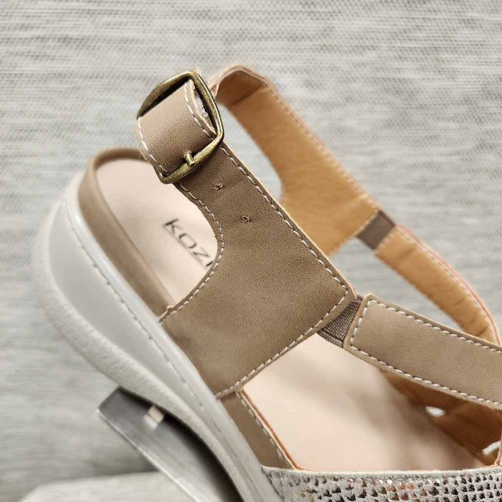 Buckle closure of sandal with taupe and shimmery straps