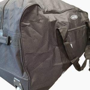 Side view of travel bag with two wheels, a top handle and strap