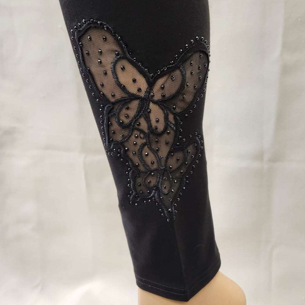 Lace detail with black beads on side of black leggings