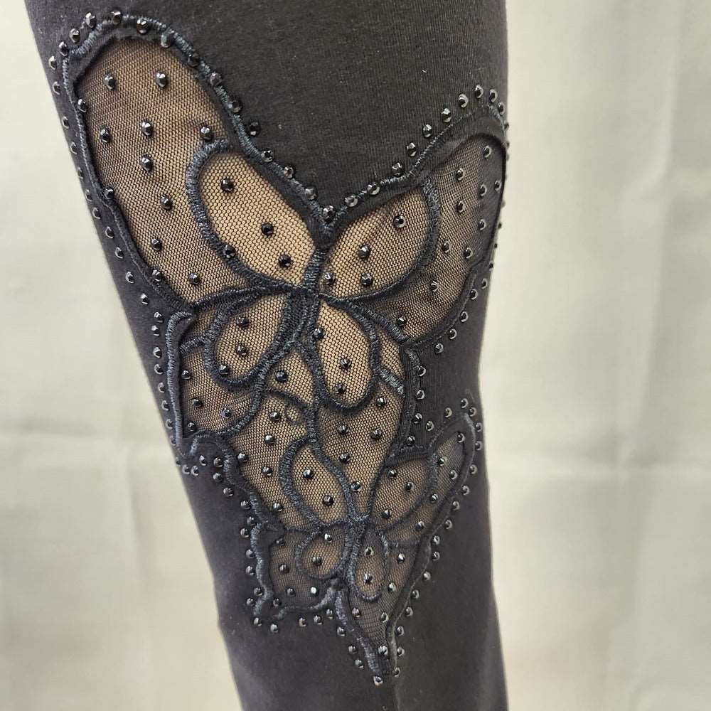 Alternative view of lace detail on side of black leggings