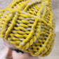 Detailed view of Winter beanie in yellow and grey multicolored yarn