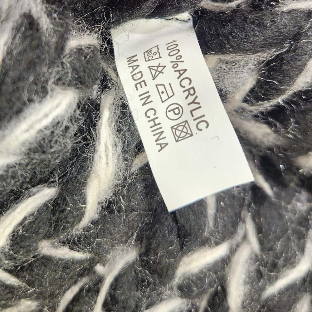 Inside tag on Winter beanie in black and white multicolored yarn
