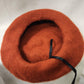 Inside view of French beret cap in rust color